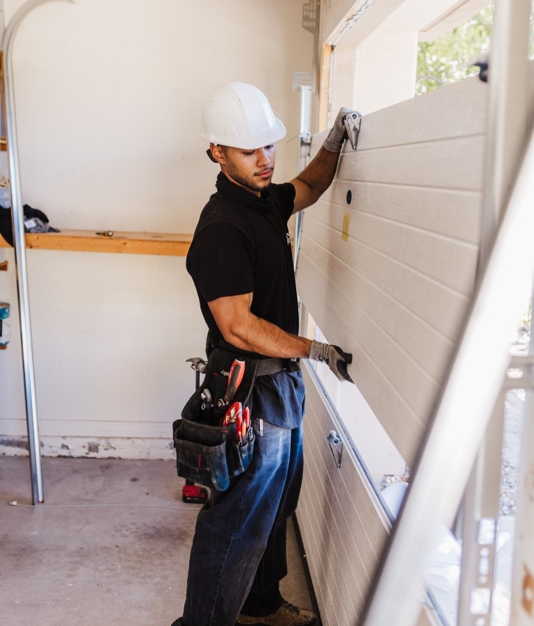 Wayne Dalton Sales & Service technician replacing garage door panel