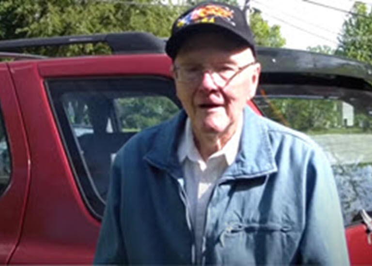 old man drives through garage door