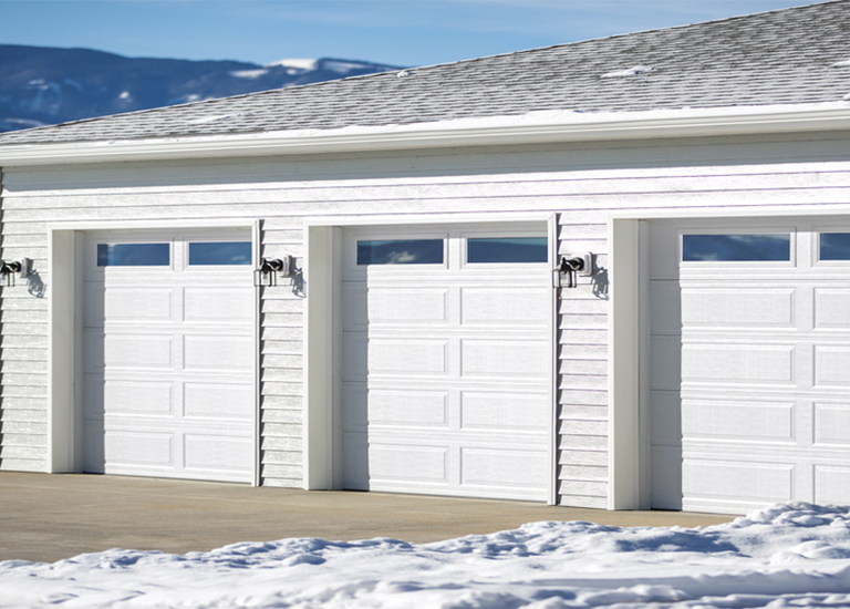 white garage doors with snow and mountains