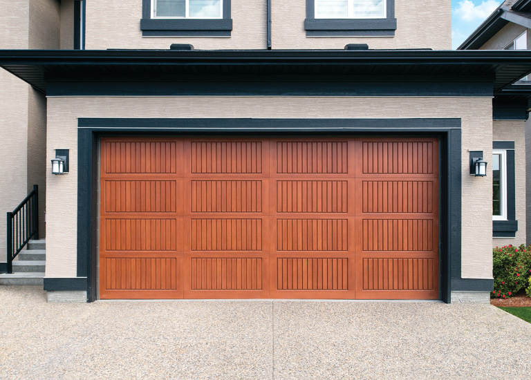 red oak garage door with black trim around home