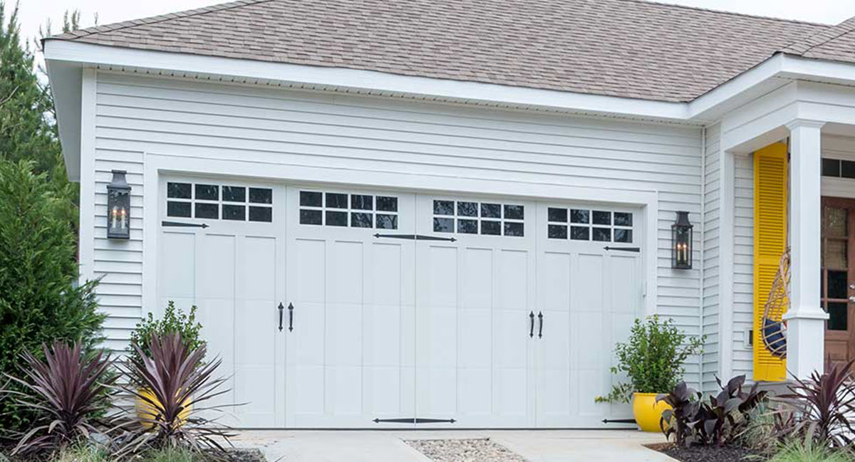 white carriage house garage door brunswick panel with windows and hardware