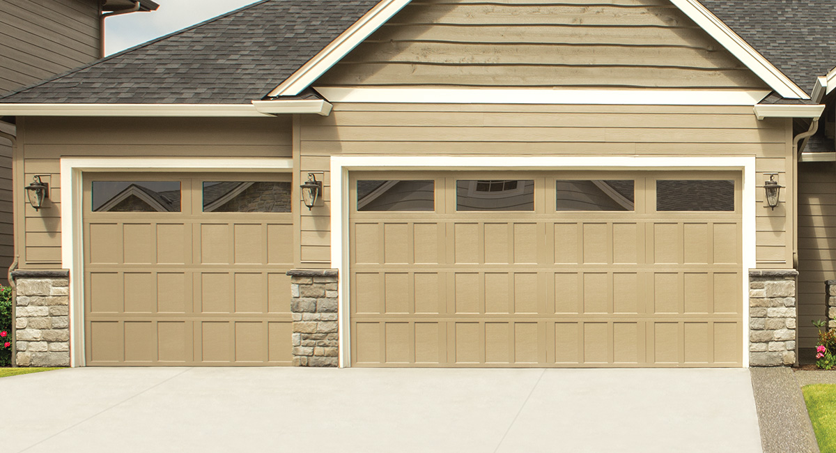 clay carriage house garage door with 6 rectangle windows on tan home