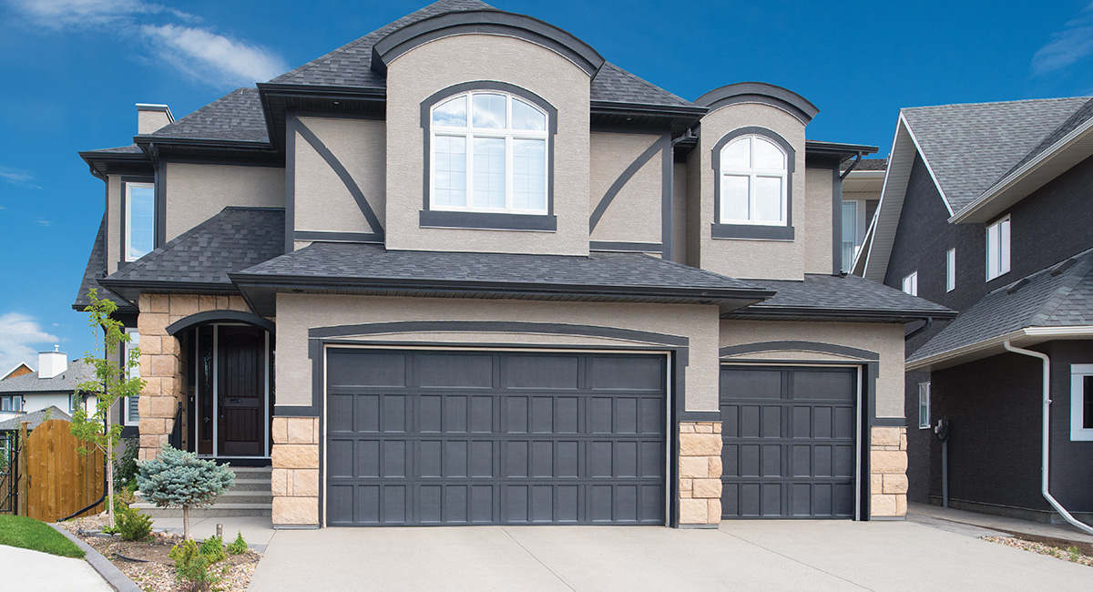 gray carriage house garage door on house with gray trim