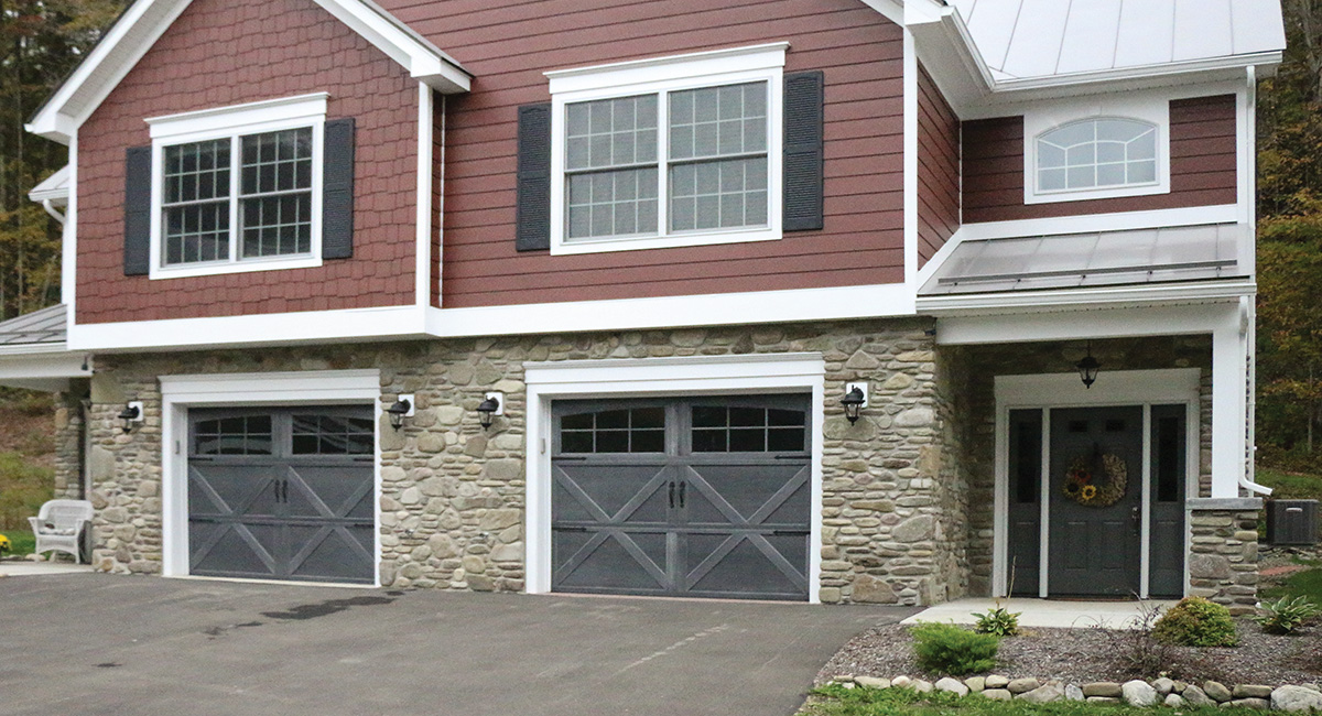 two gray carriage house garage doors with