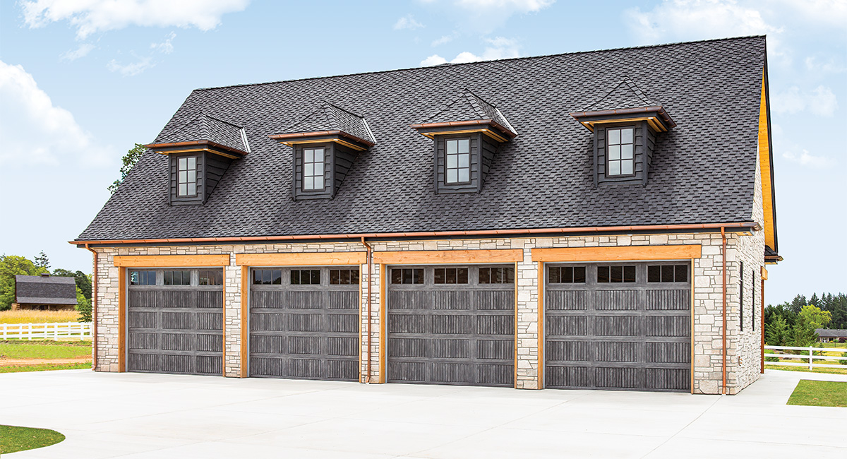four gray fiberglass garage doors on a detached garage with 9 windows on each door