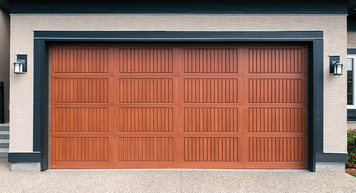 red oak fiberglass garage door with one light on each side of the door and black trim on home