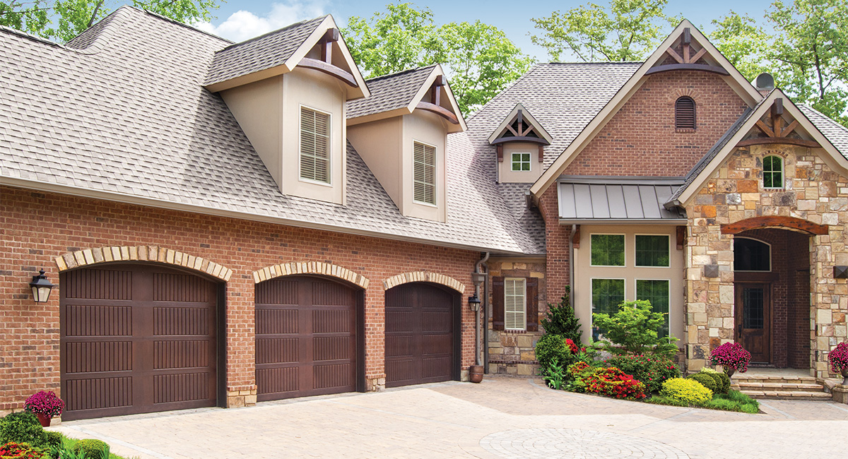 three walnut fiberglass garage doors