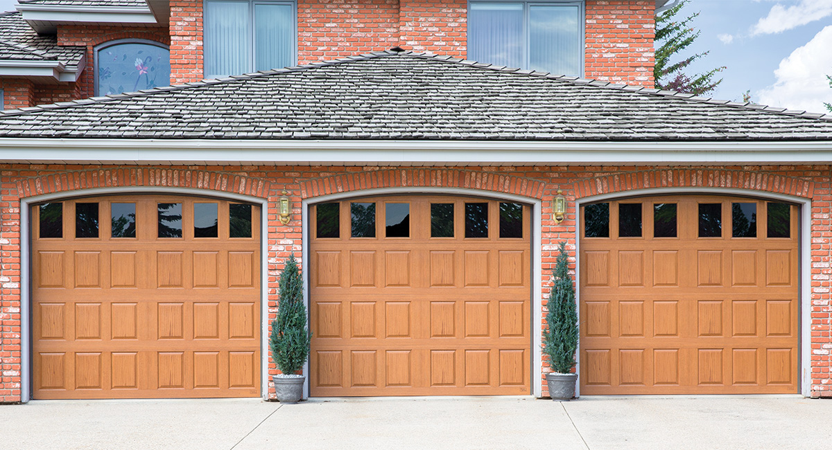 three natural oak fiberglass garage doors with eighteen vertical windows