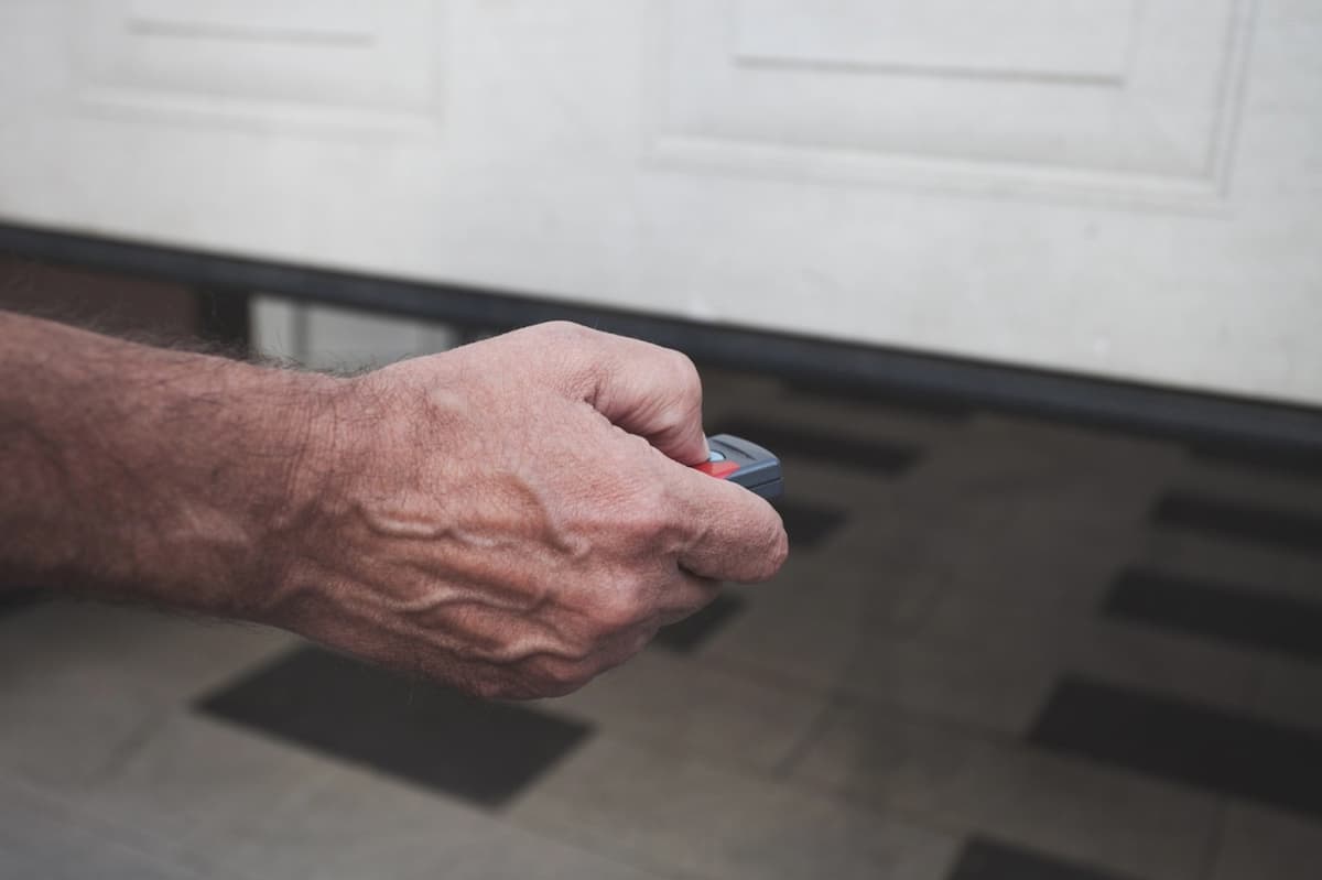 homeowner using garage door remote