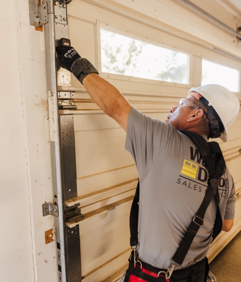 Wayne Dalton Sales & Service technician inspects noisy garage door