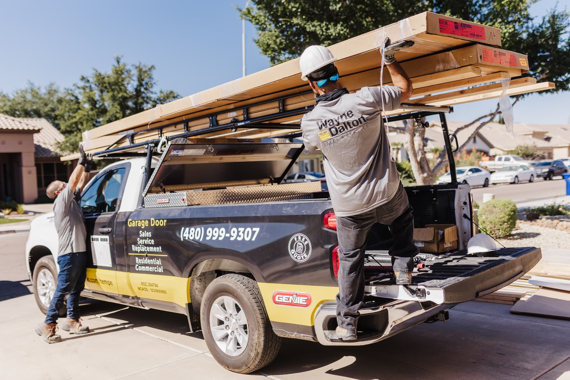 Wayne Dalton Sales & Service technicians unloading garage door panels from truck