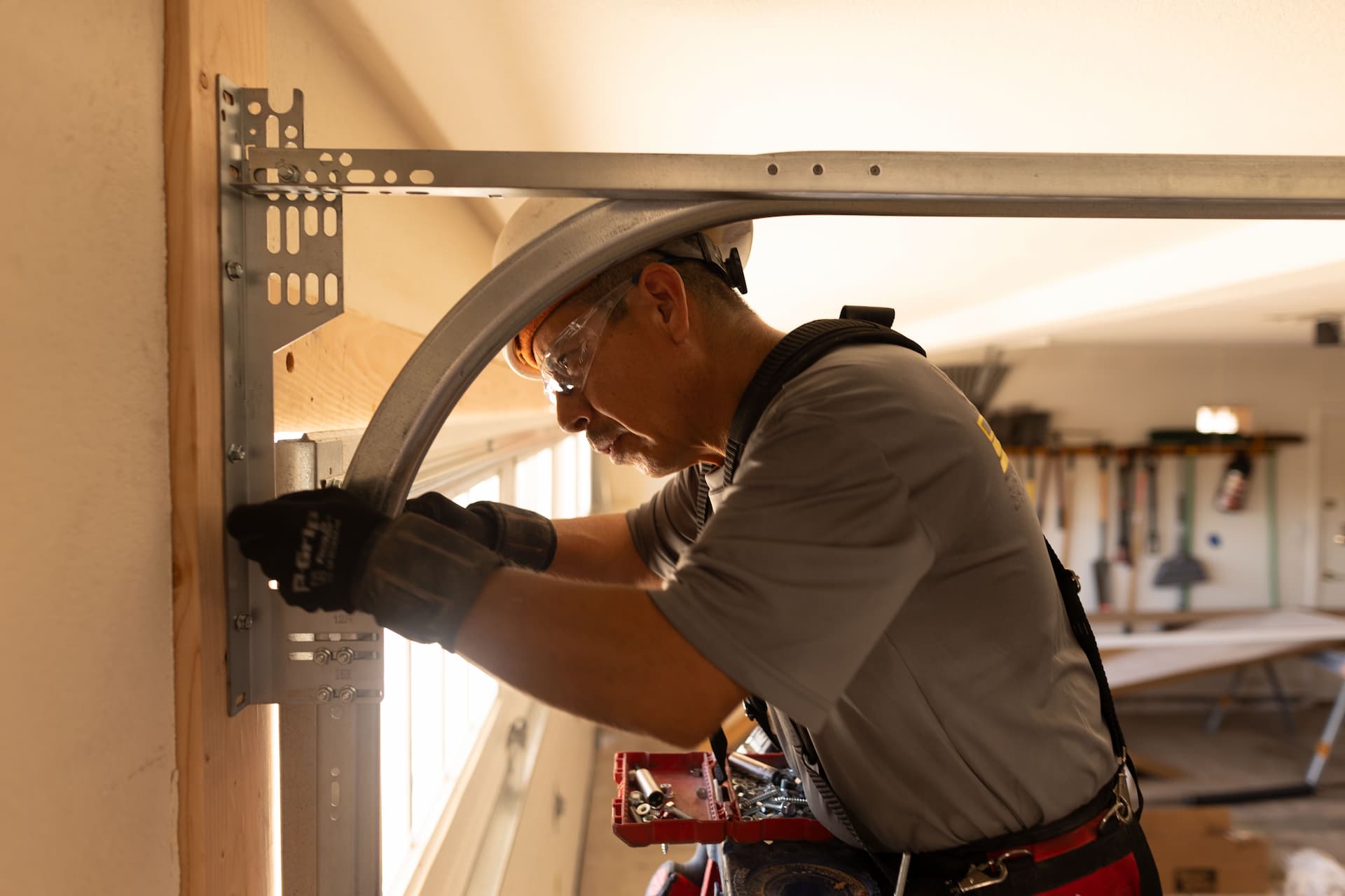Wayne Dalton Sales & Service technician performing maintenance on garage door track