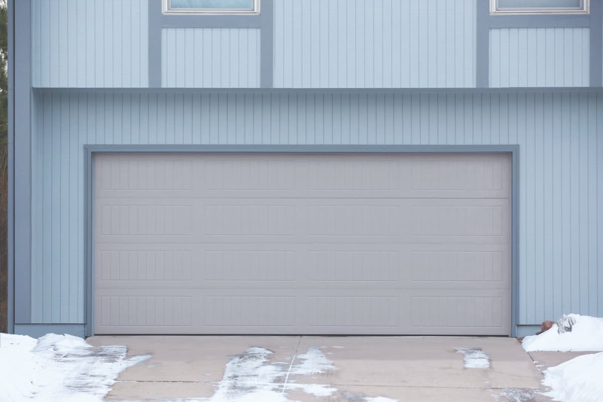 Wayne Dalton Model 9100 garage door with weather stripping to protect against snow on the ground