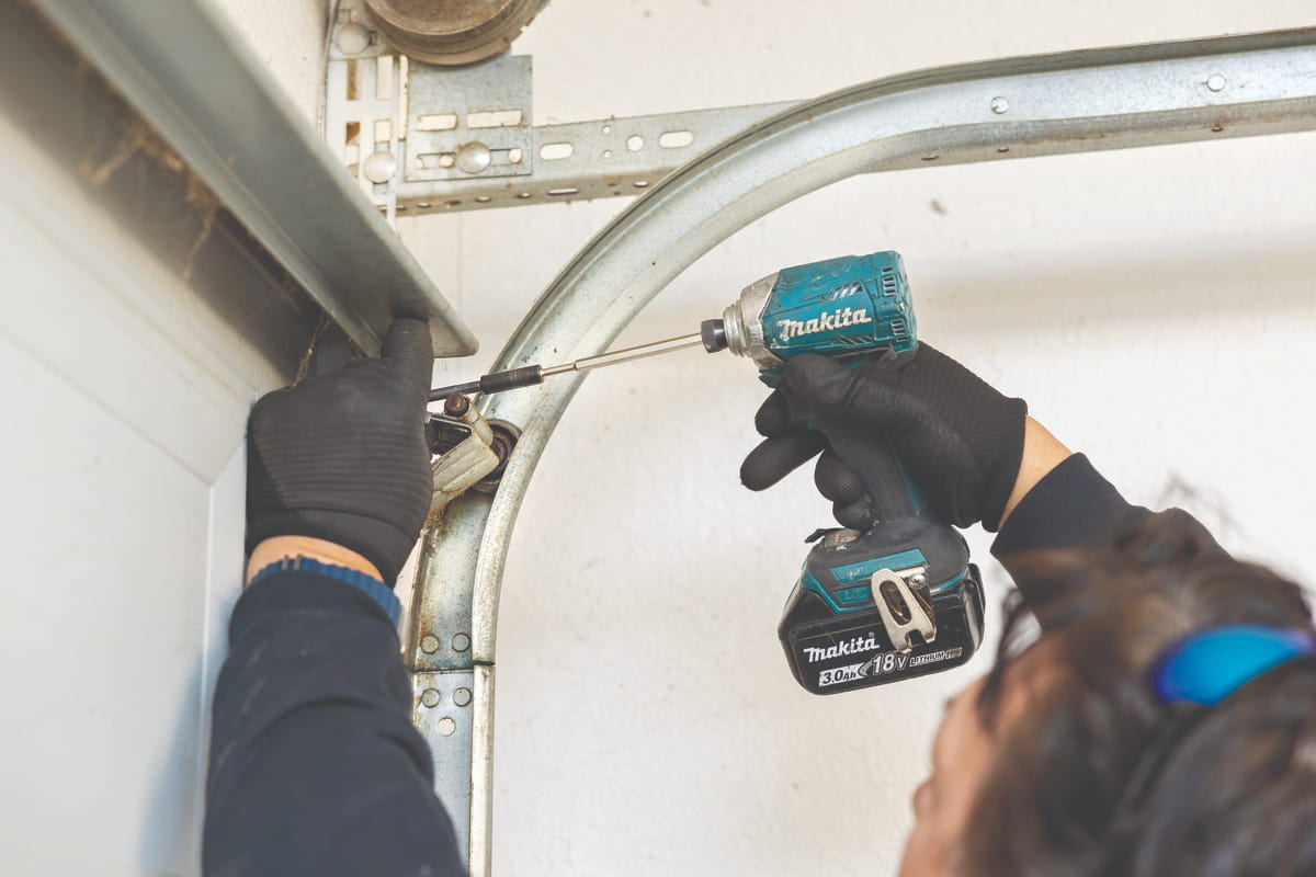 Wayne Dalton Sales & Service technician adjusting garage door roller