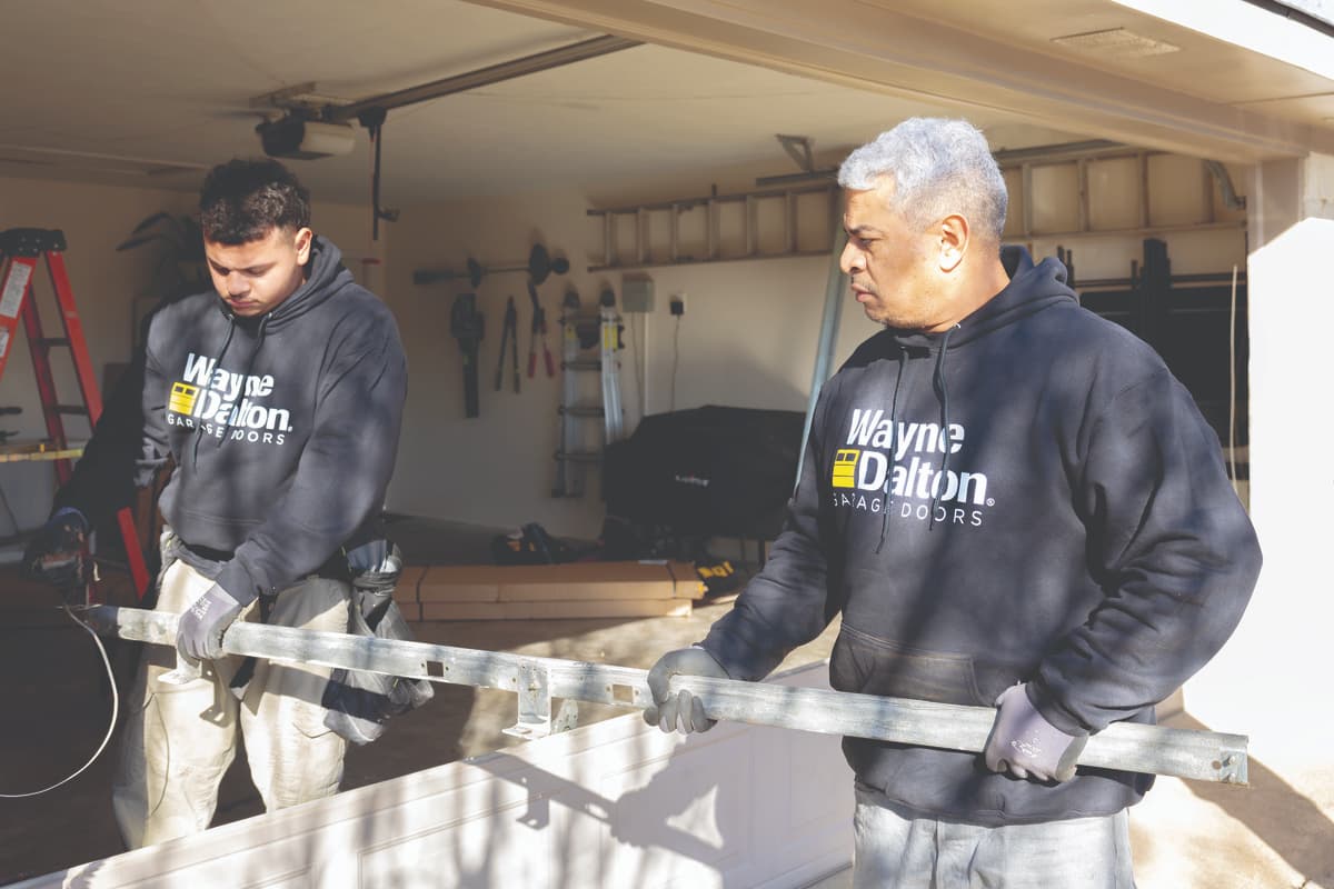 Wayne Dalton Sales & Service technicians with replacement garage door track